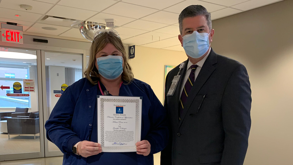 Nurse holding award with president