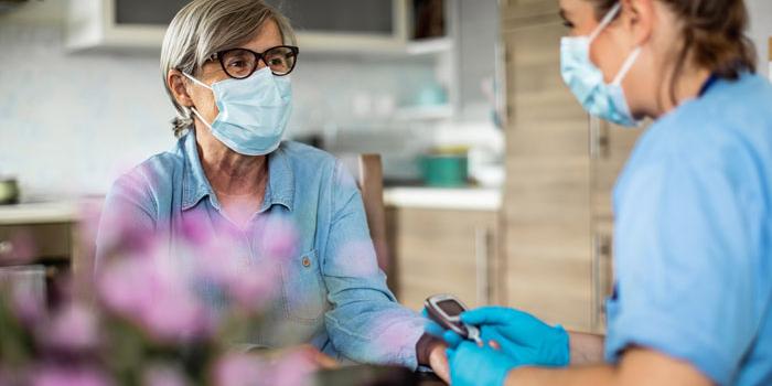 nurse tending to elderly patient